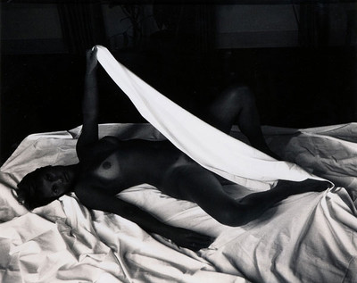 [Nude female on bed with sheets]