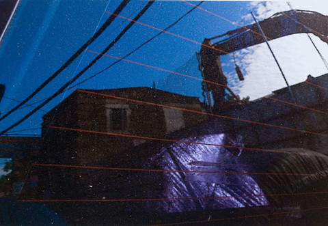 Stuart Shils: Germantown Avenue Building Beyond Coulter Street, Reflected Through a Rear Window of a Car (2009) Archival pigment print